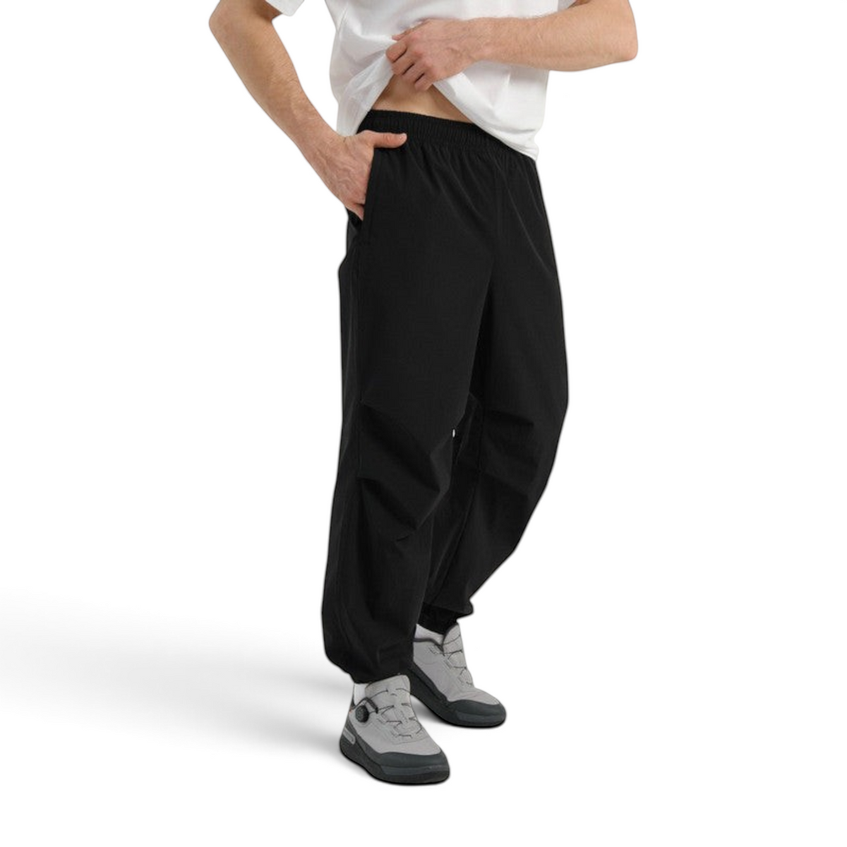 FRG COMMUTE relaxed black woven trousers with an elasticated waistband worn by a man in a white t-shirt