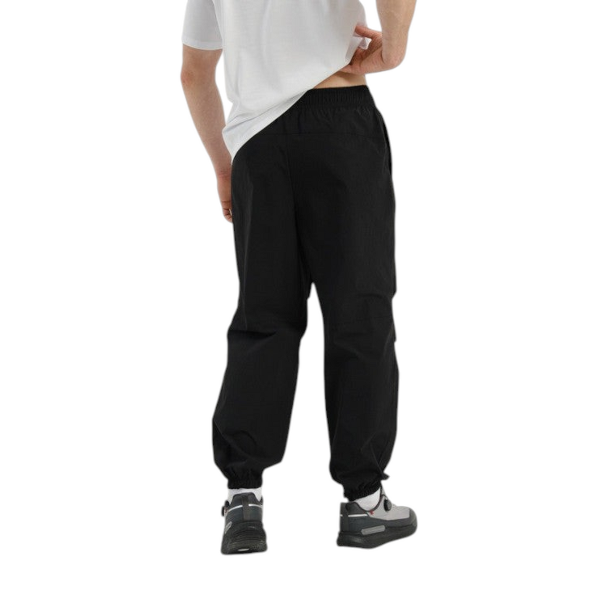 FRG COMMUTE black woven textile trousers with elasticated cuffs worn by a man, back view