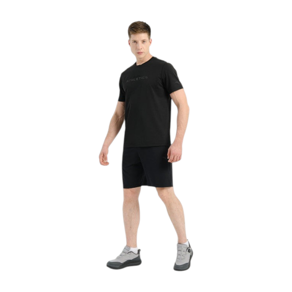 FRG model wearing Anta black knit training shorts and a matching black t-shirt against a white background