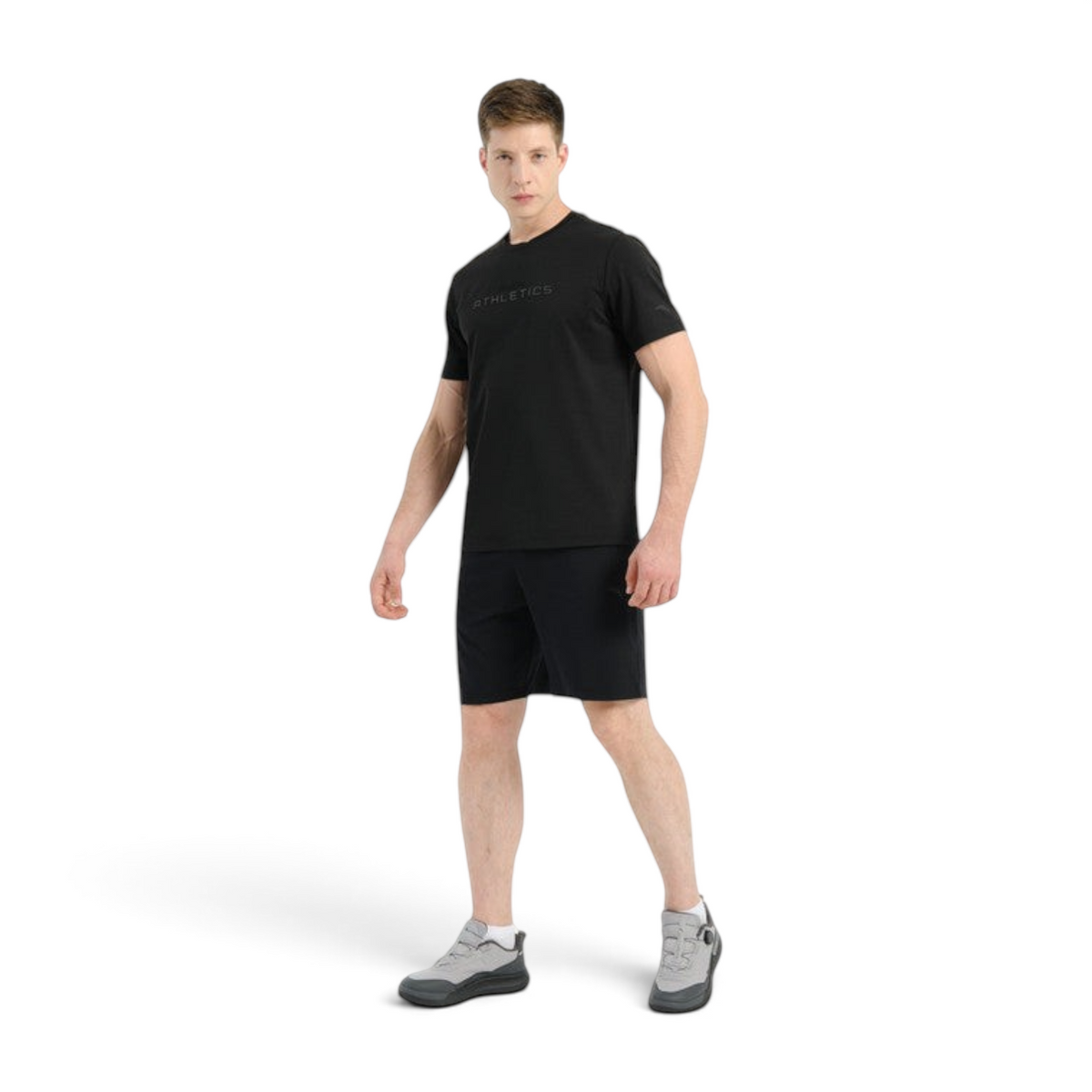FRG model wearing Anta black knit training shorts and a matching black t-shirt against a white background