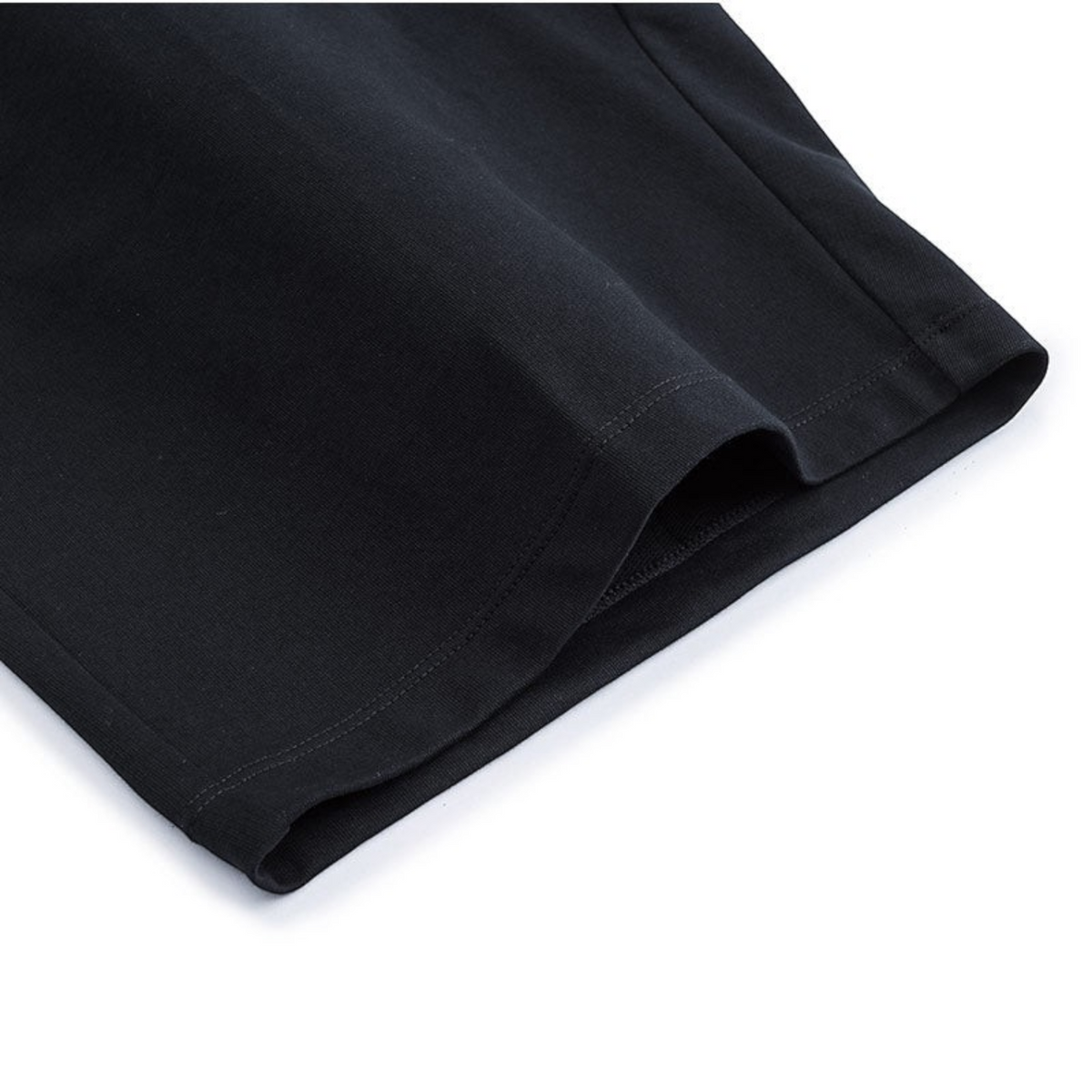 Close-up of the hem on a pair of black FRG knit half pants featuring soft cotton fabric and clean stitching.