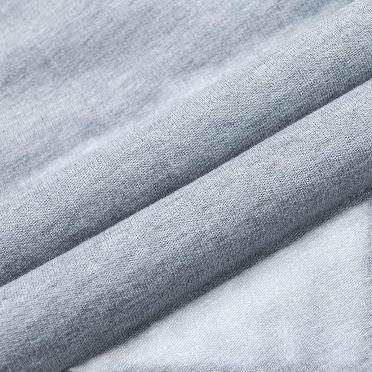 Close-up of FRG ANTA heather grey knit fabric showing the soft cotton-polyester blend texture and weave.