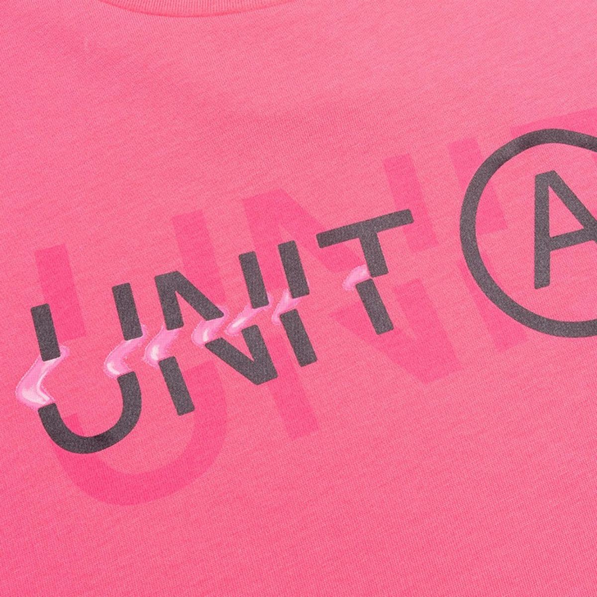 FRG SS TEE in bright pink cotton featuring a layered black and glossy pink UNIT graphic print on the chest