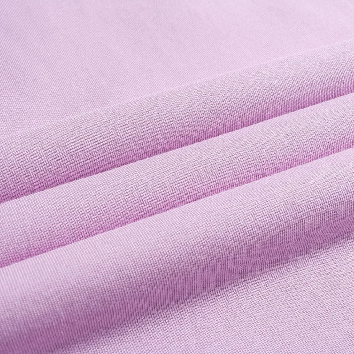 Close-up of soft light purple cotton fabric from a FRG SS TEE showing the fine knit texture and folds