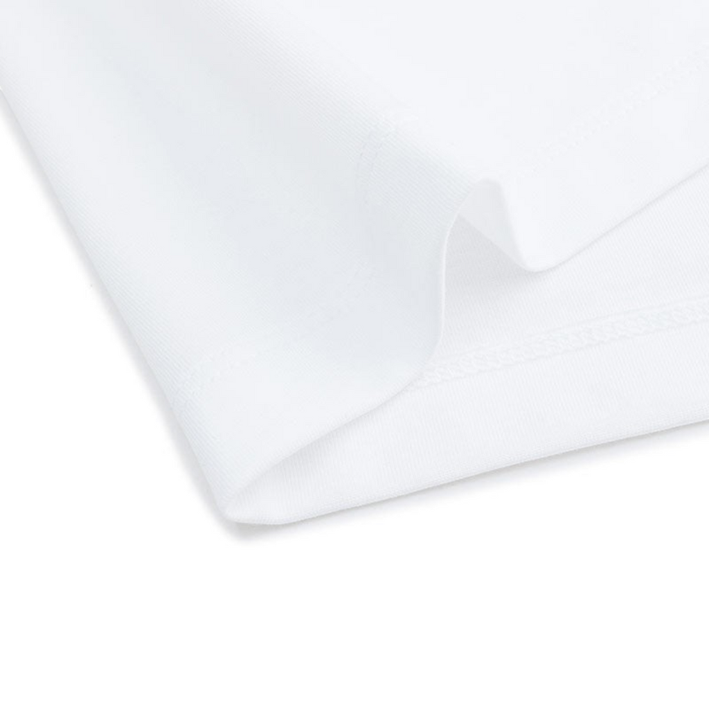 Close-up of a plain white FRG short sleeve t-shirt fabric showing the hem and soft cotton texture