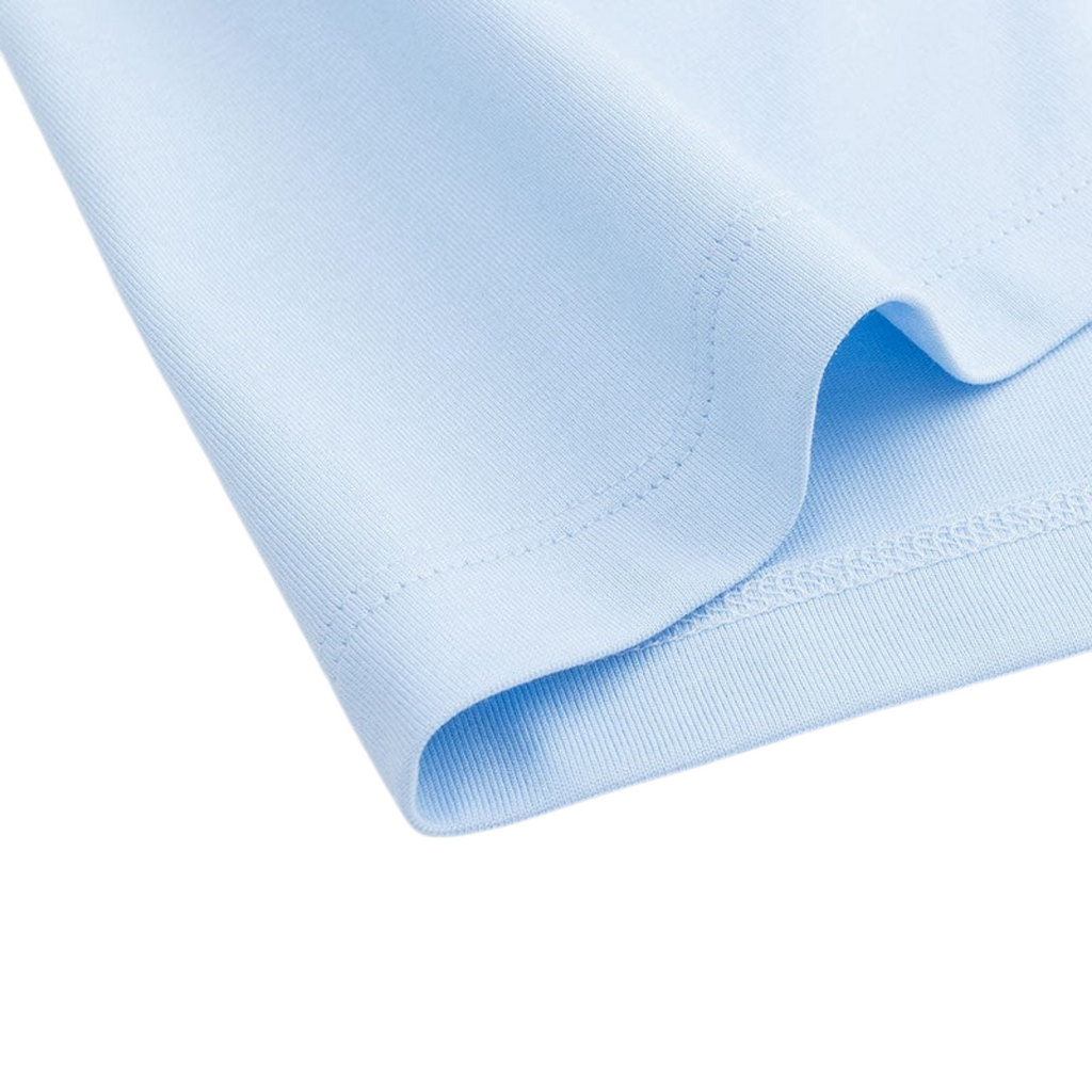 Close-up of the hem of a light blue FRG SS TEE showing the smooth cotton fabric and detailed stitching.