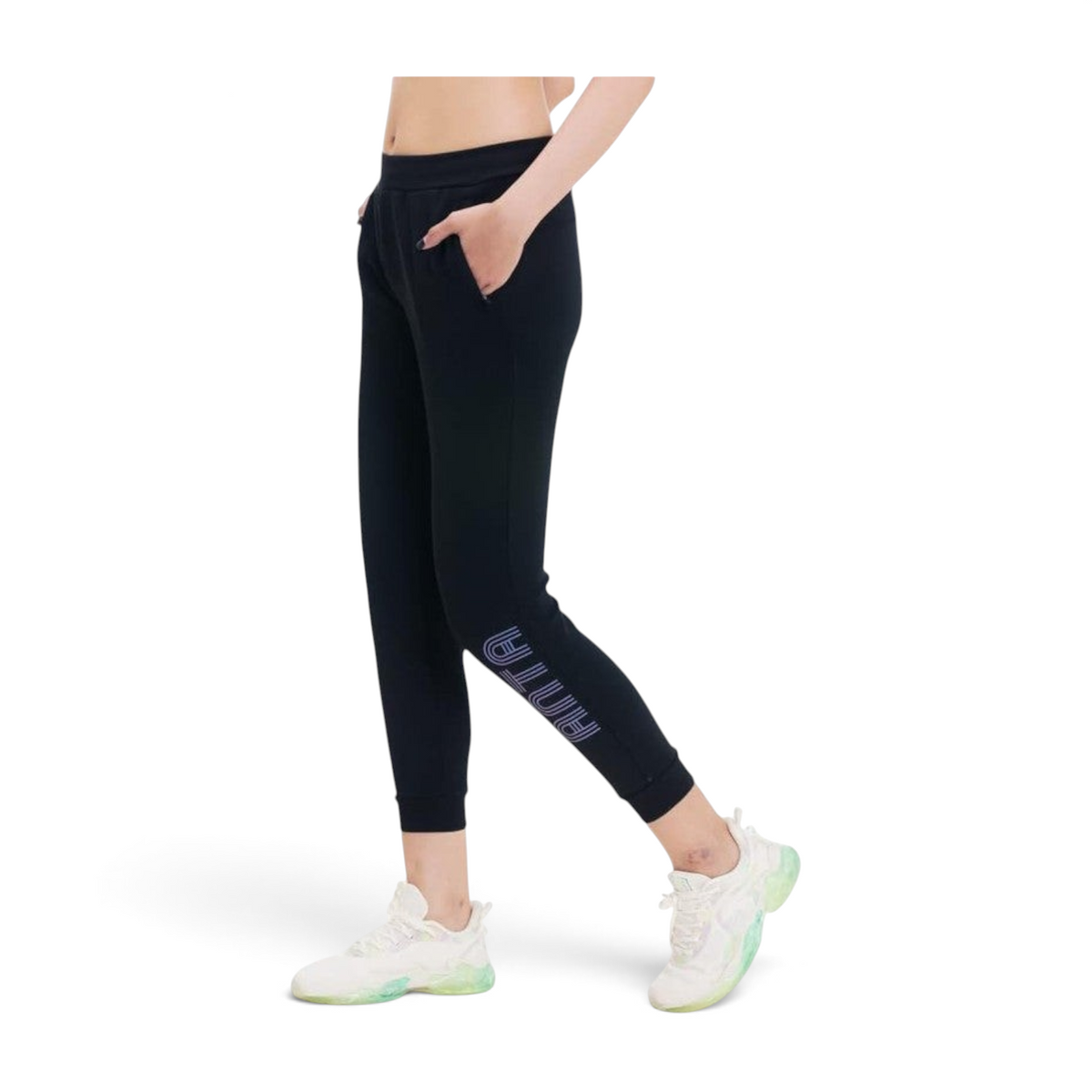 FRG ANTA black knit ankle training pants with four-way stretch and side logo on a model wearing white sneakers