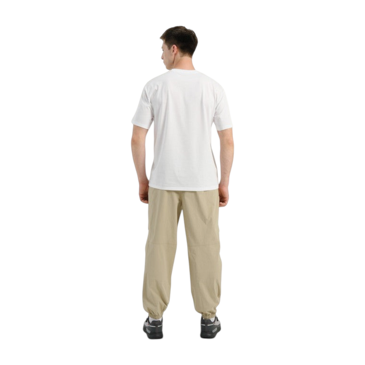 Back view of a man wearing FRG COMMUTE relaxed beige woven track pants with elastic cuffs and a white t-shirt