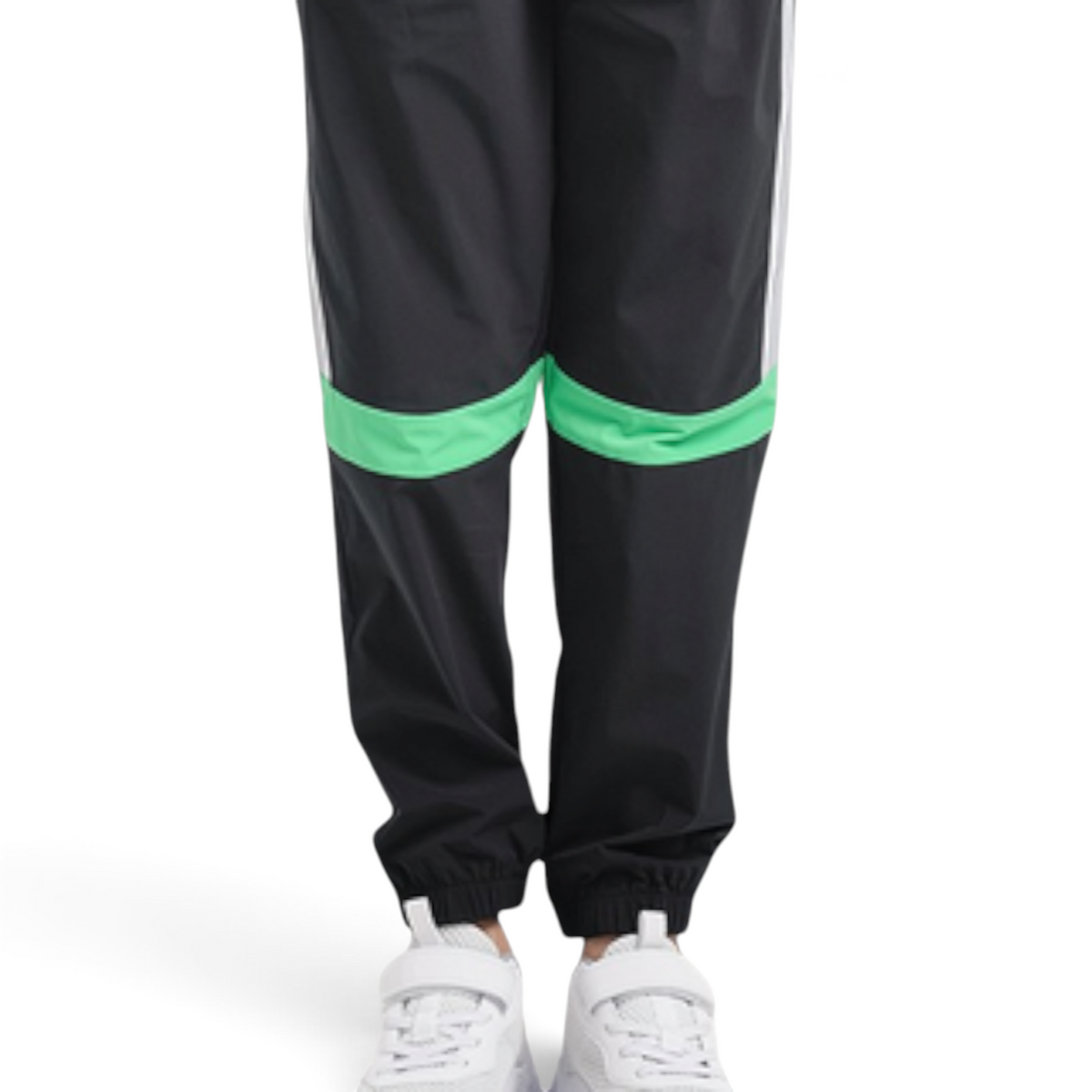 FRG ANTA black woven track pants with green knee panels and white side stripes worn by a child in white sneakers.