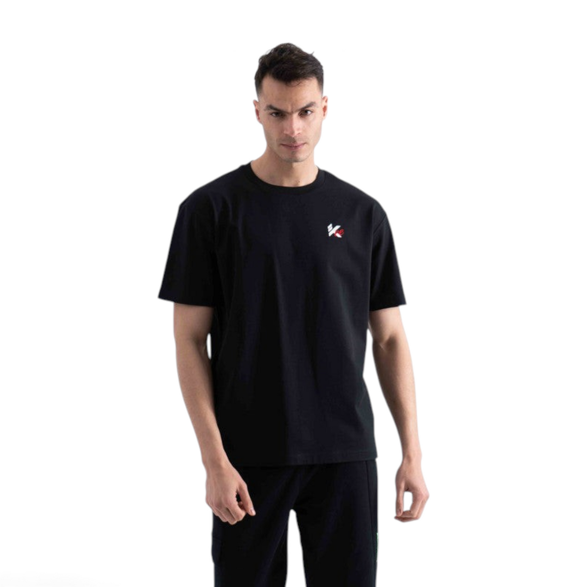 A man wearing a black FRG SS TEE with a small white and red logo on the chest against a plain white background.