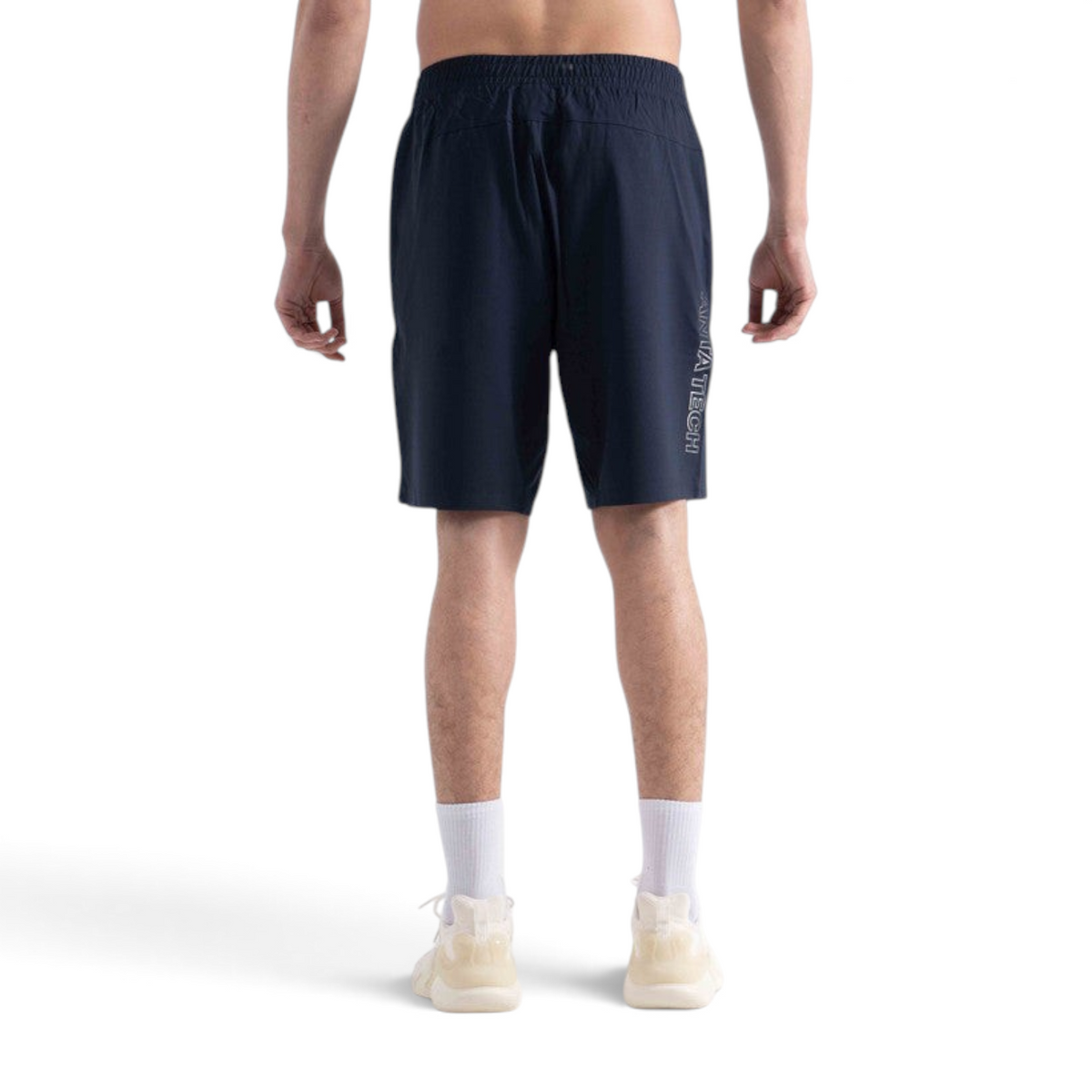 FRG navy knit half pants worn by a man, featuring a side logo detail, back view on a white background.