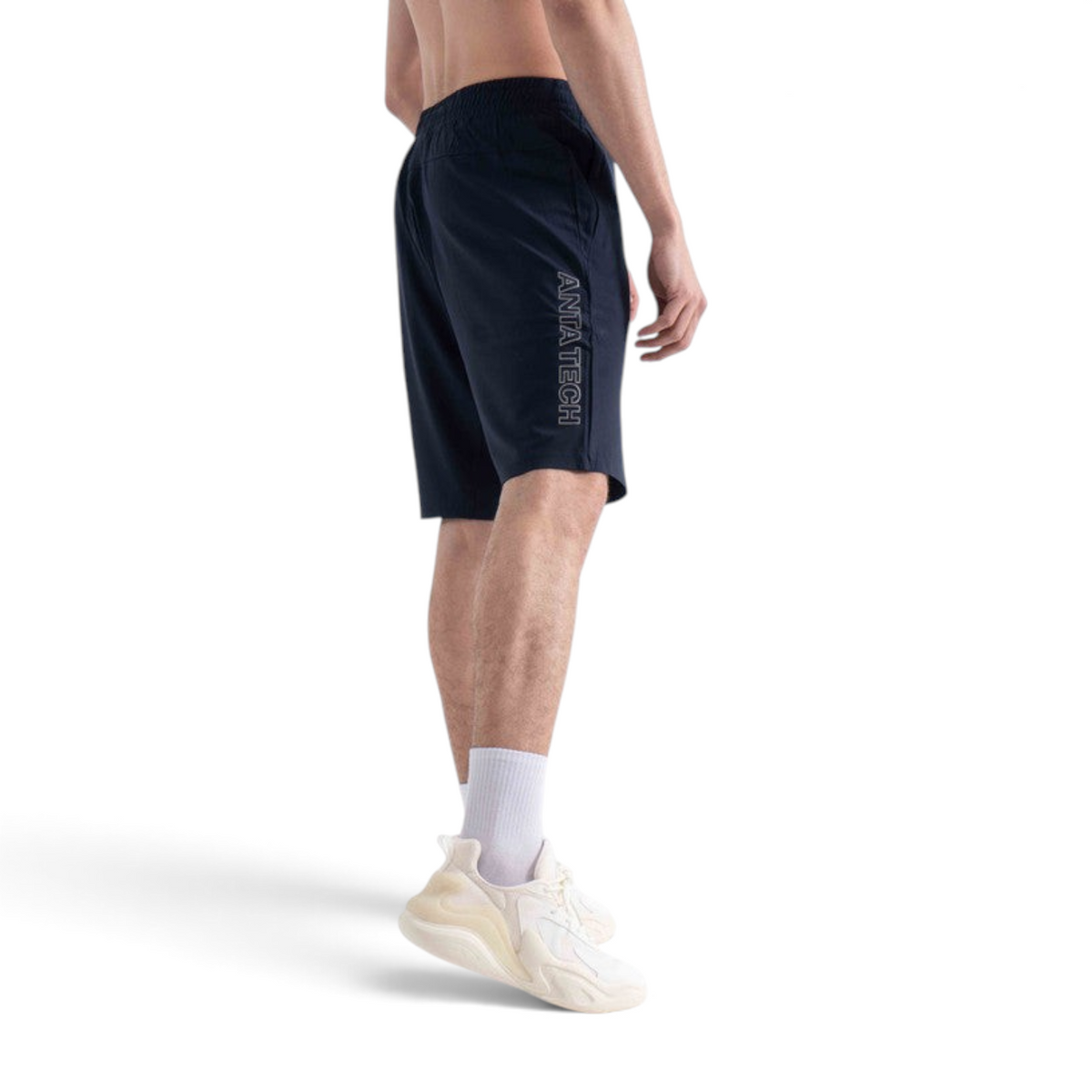 FRG navy knit half pants featuring ANTA TECH logo on the side, worn by a man with white socks and sneakers