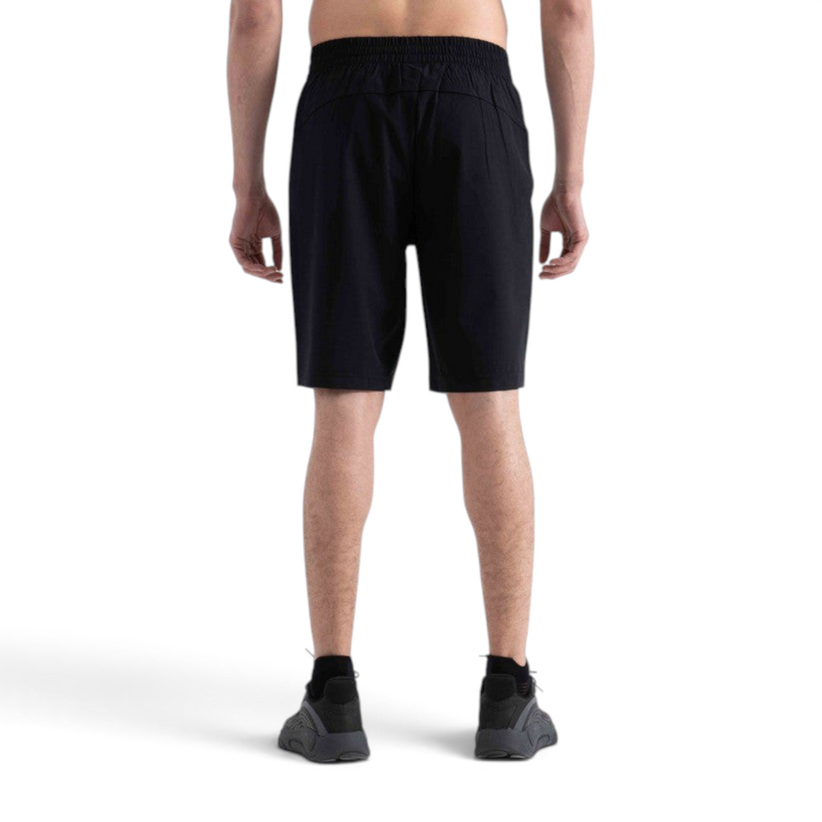 Back view of FRG black athletic half pants on a model, featuring an elastic waistband and lightweight fabric.
