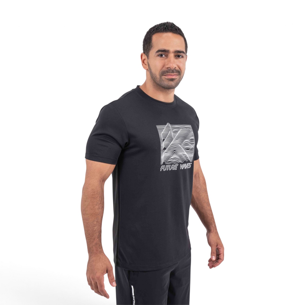 A man wearing a black FRG T-shirt with a white Future Waves graphic print on the chest, isolated on white.