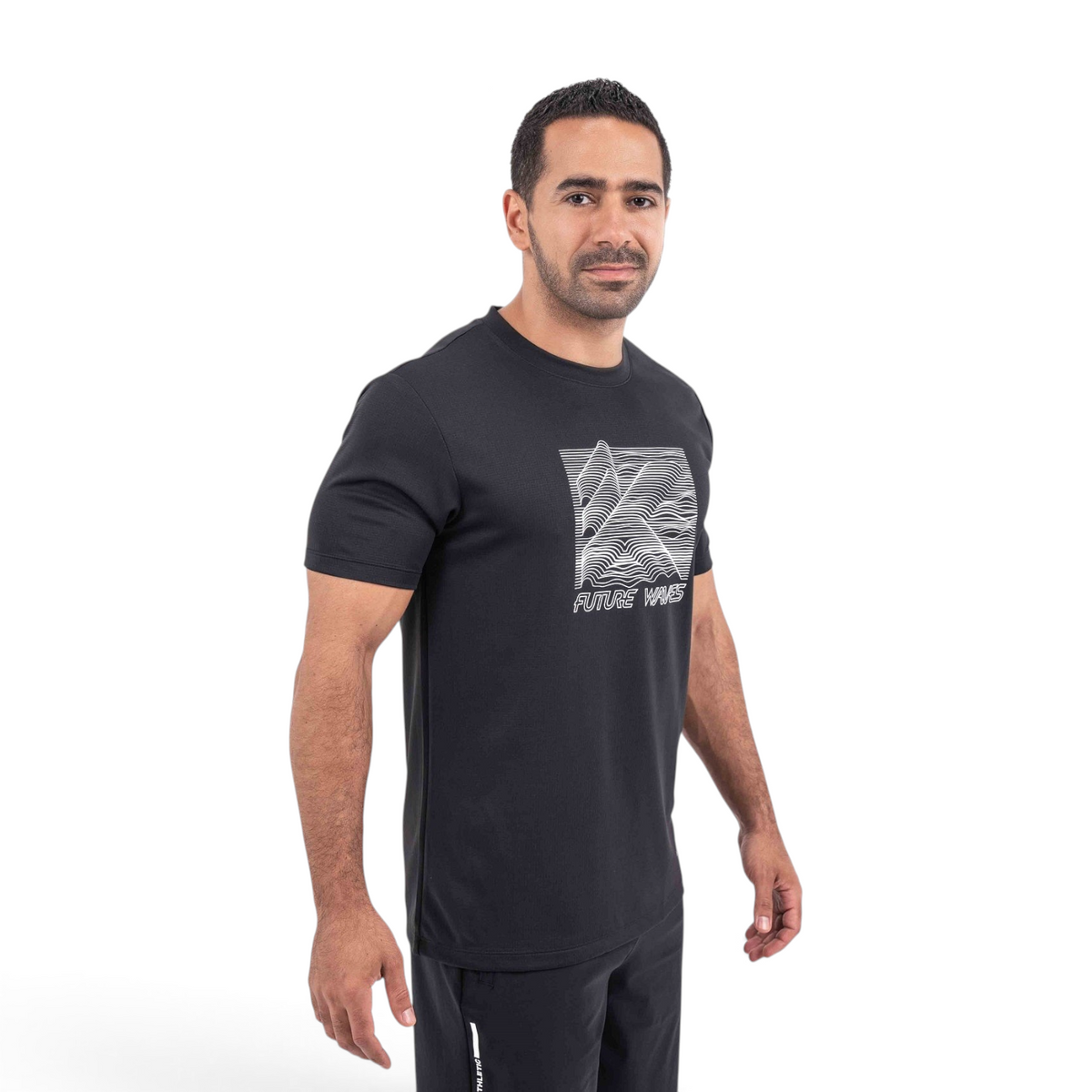 A man wearing a black FRG crew neck t-shirt with a white Future Waves graphic print on the chest.