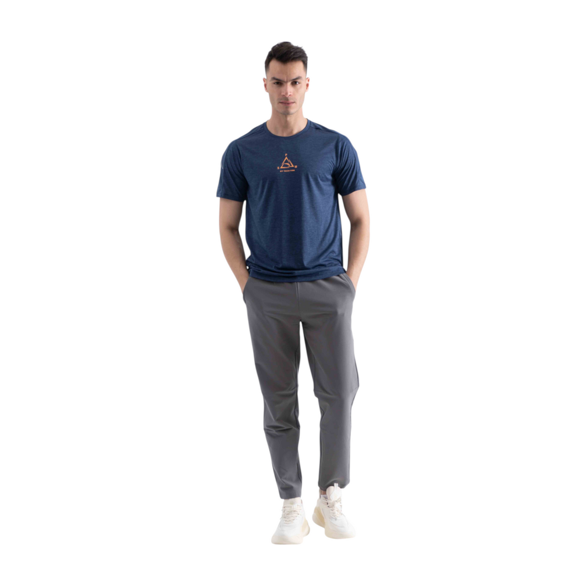 FRG cross training t-shirt in navy blue with a small orange graphic, worn by a man with grey trousers and sneakers.