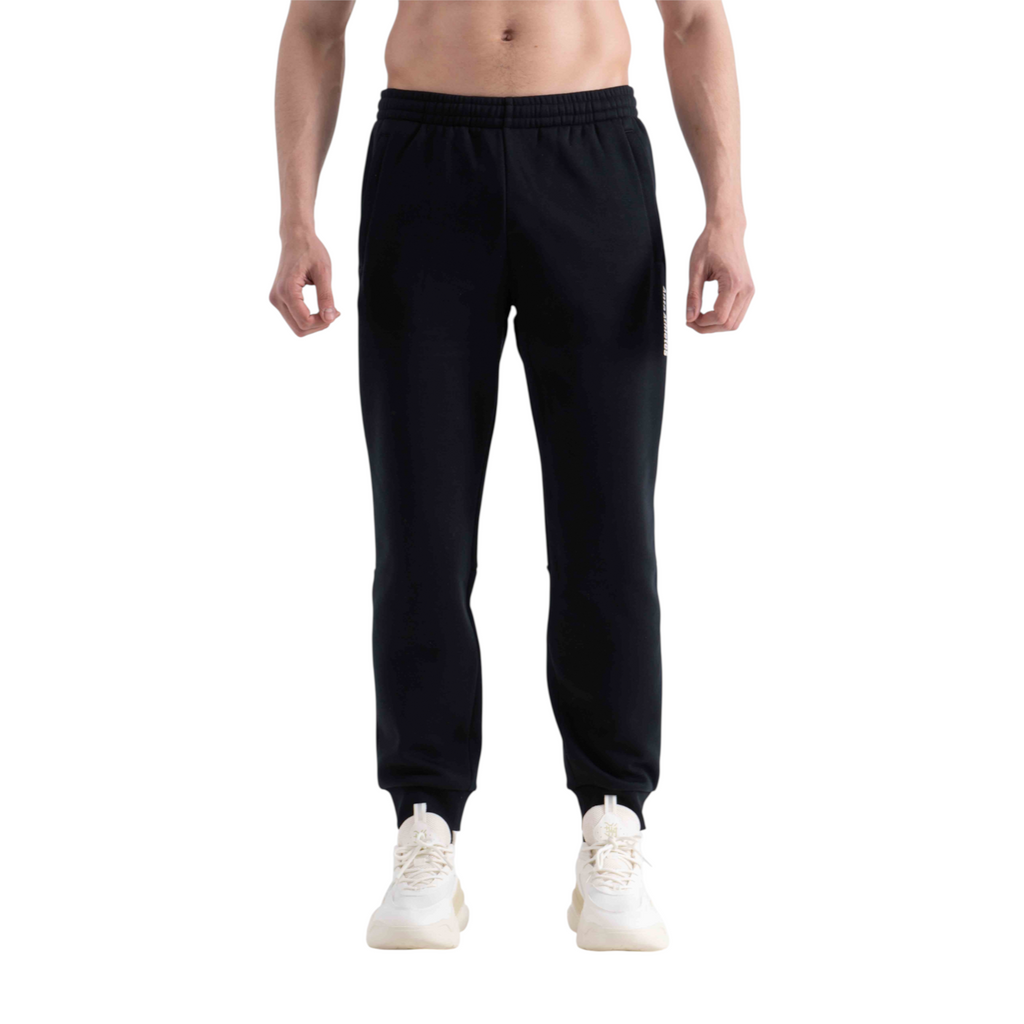 FRG black knit track pants with elasticated cuffs worn by a shirtless man against a white background