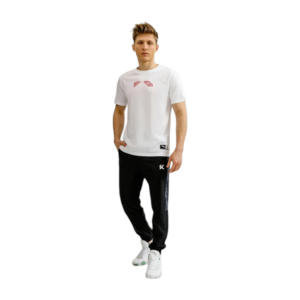 FRG Anta relaxed-fit black basketball pants with water-resistant coating worn by a man in a white t-shirt