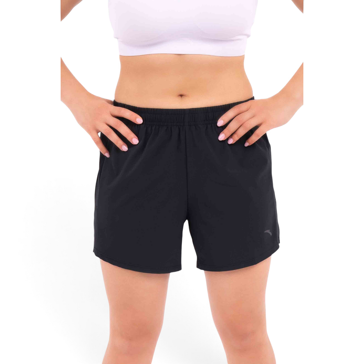 FRG black athletic shorts with an elastic waistband worn by a woman with a white sports bra