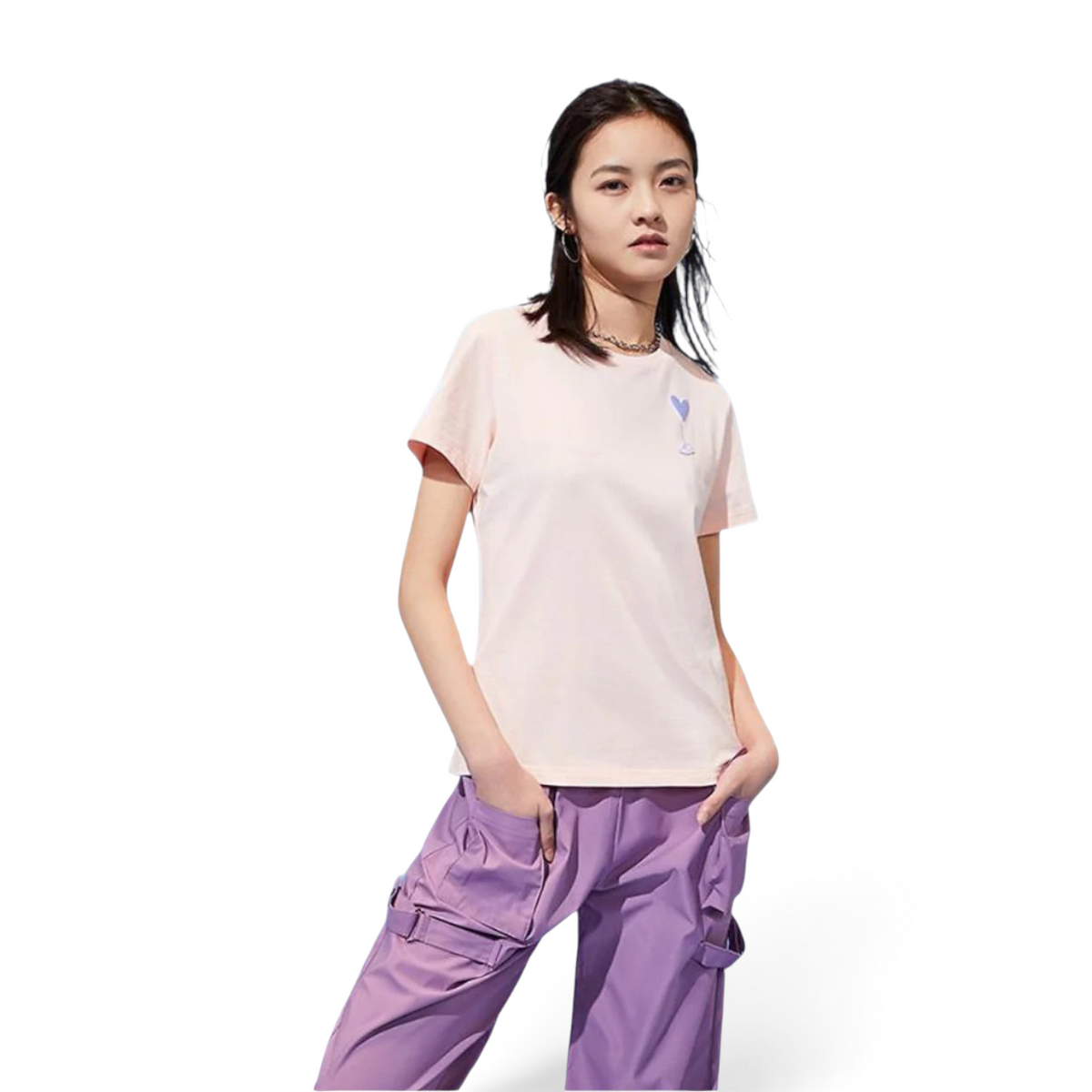 FRG light pink short-sleeve t-shirt with a small heart graphic worn by a woman with purple cargo pants