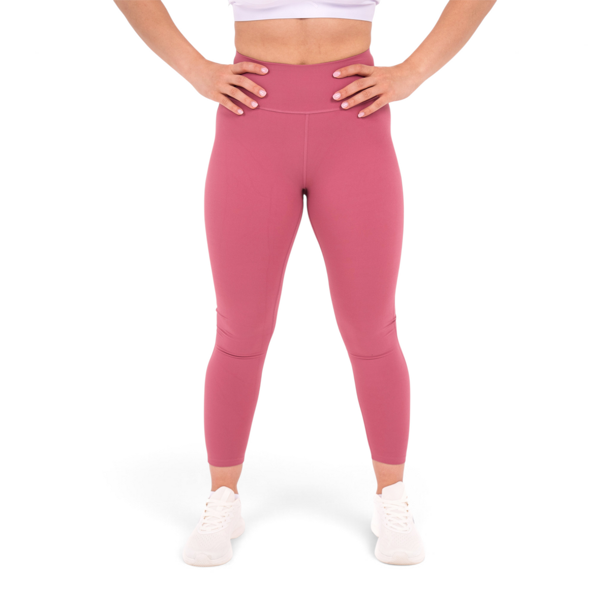 FRG slim fit tight ankle pants in dusty rose polyamide spandex blend worn by a woman with hands on hips