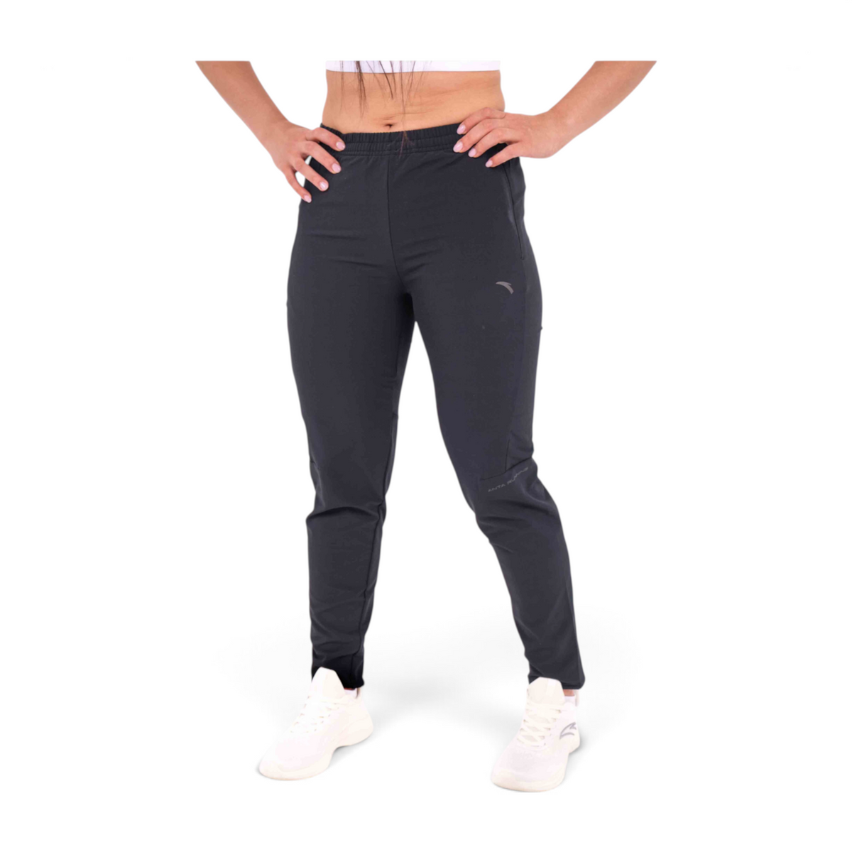 FRG slim fit black woven track pants made from polyester and spandex blend worn by a woman with white sneakers