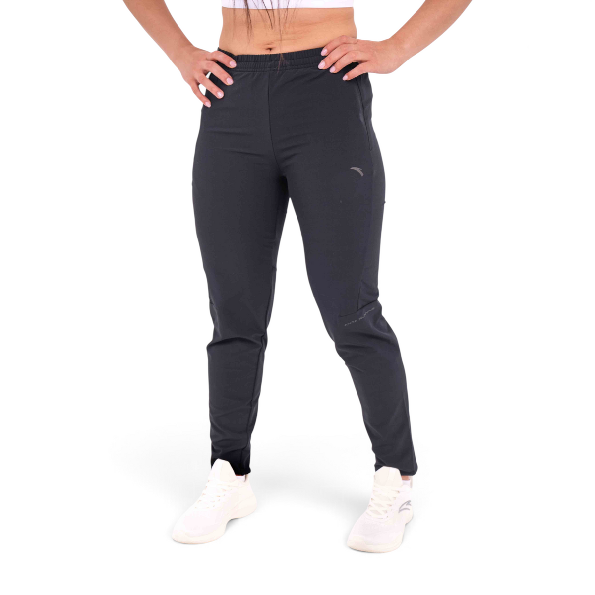 FRG slim fit black woven track pants made from polyester and spandex blend on a model