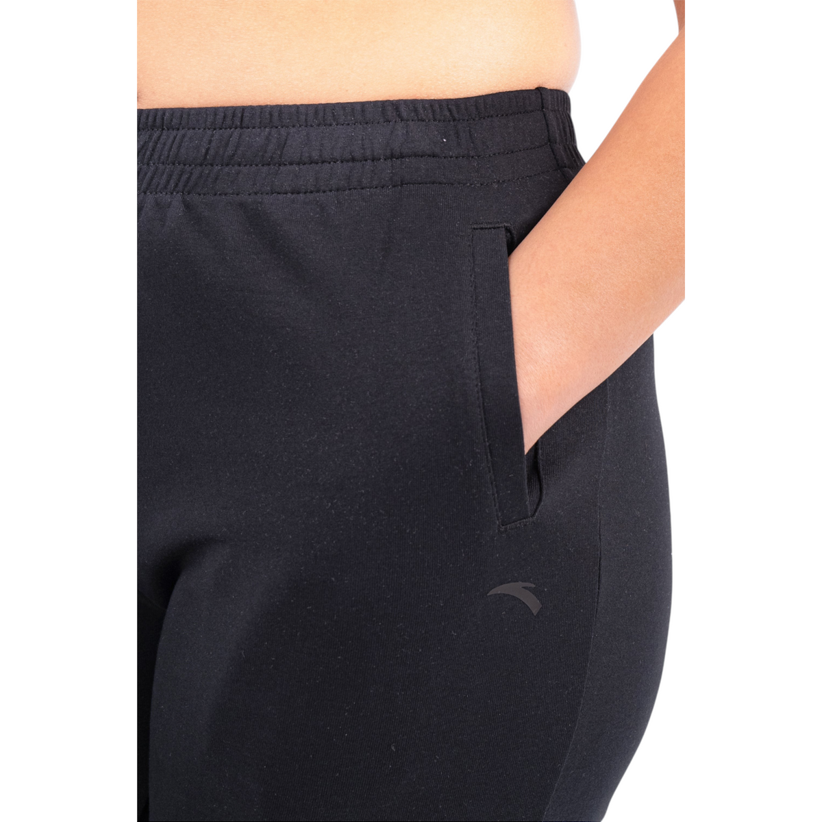 FRG black knit track pants featuring an elastic waistband and a side pocket with a subtle logo detail.