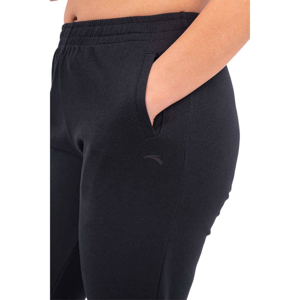 FRG black knit track pants featuring an elastic waistband and a side pocket on a model