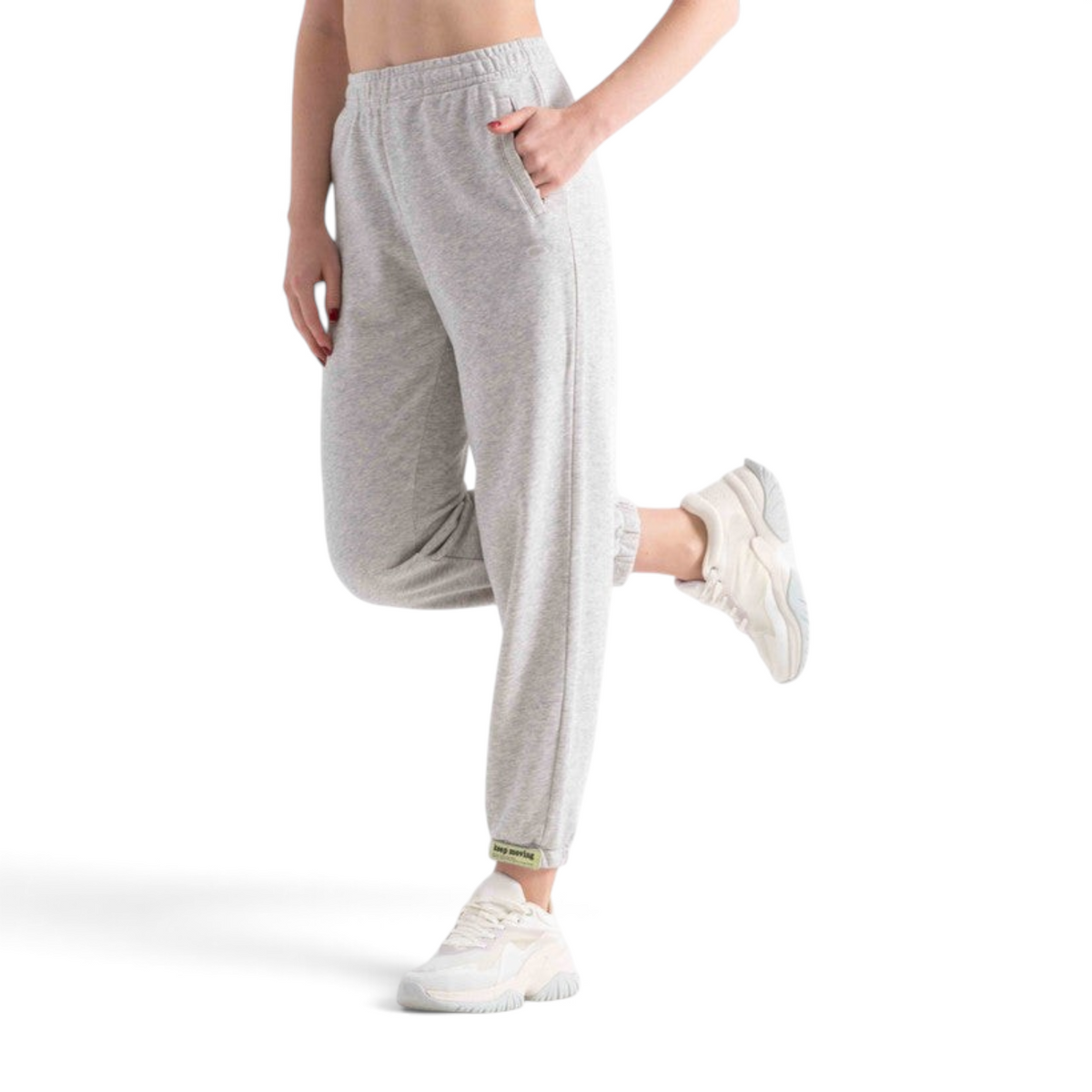 FRG knit track pants in light grey with an elastic waistband, side pockets, and cuffed ankles on a model