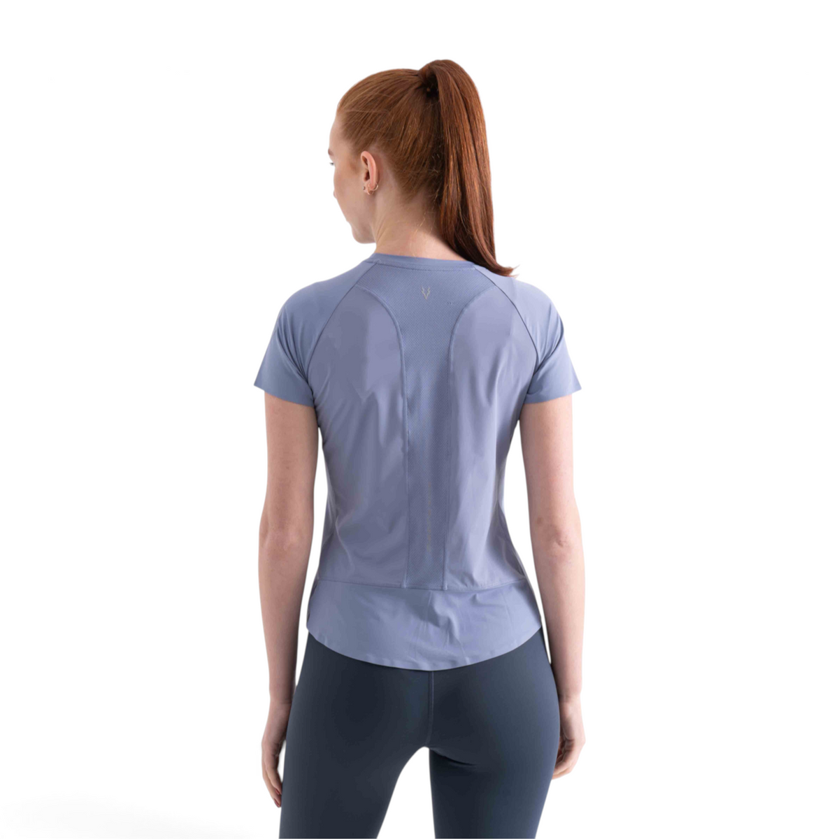 Back view of a woman wearing a FRG light blue short sleeve athletic tee with mesh panel detailing