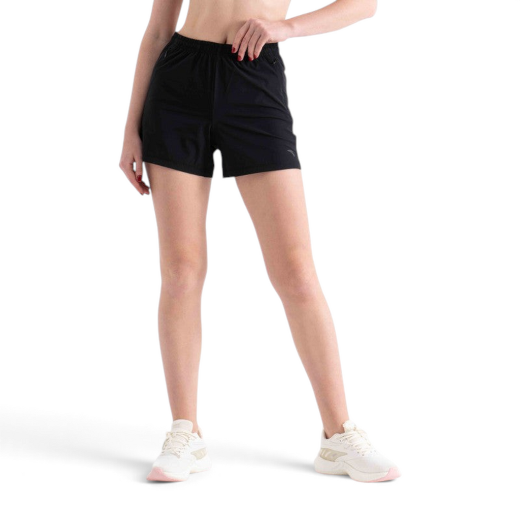 FRG black athletic shorts with an elastic waistband worn by a model with white sneakers