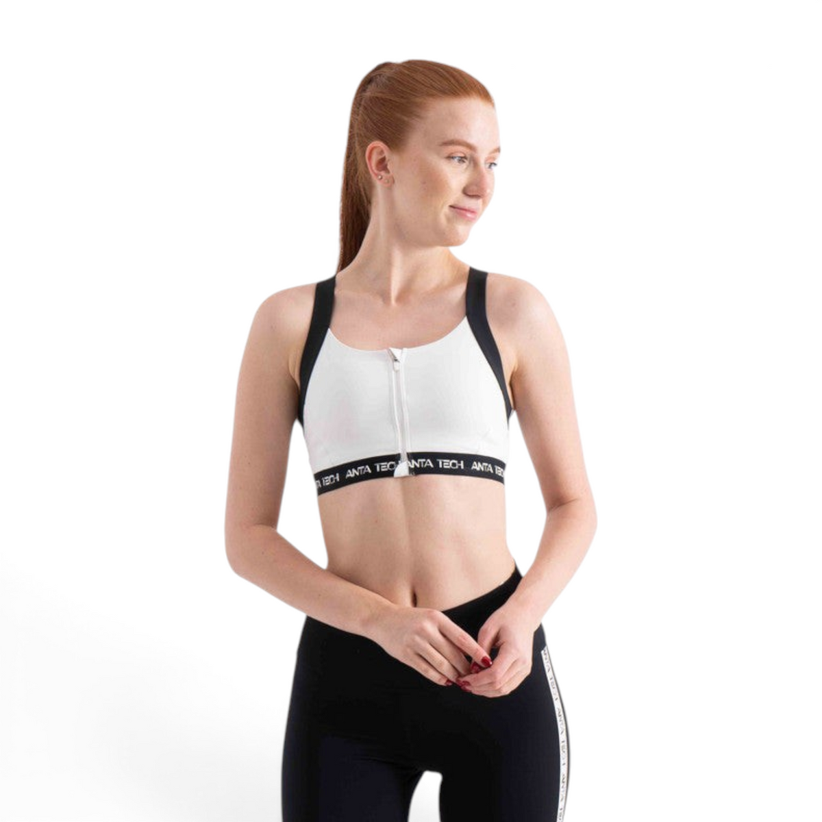FRG white sports bra with front zipper, black trim, and branded elastic band worn by a woman
