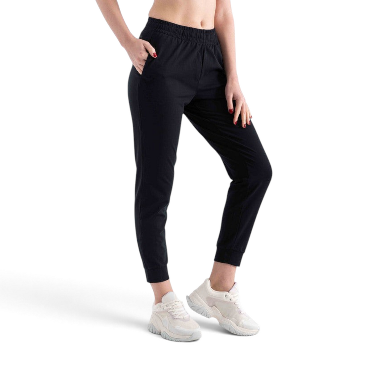 Model wearing FRG black knit ankle pants with an elastic waistband and cuffed hems, paired with white sneakers.