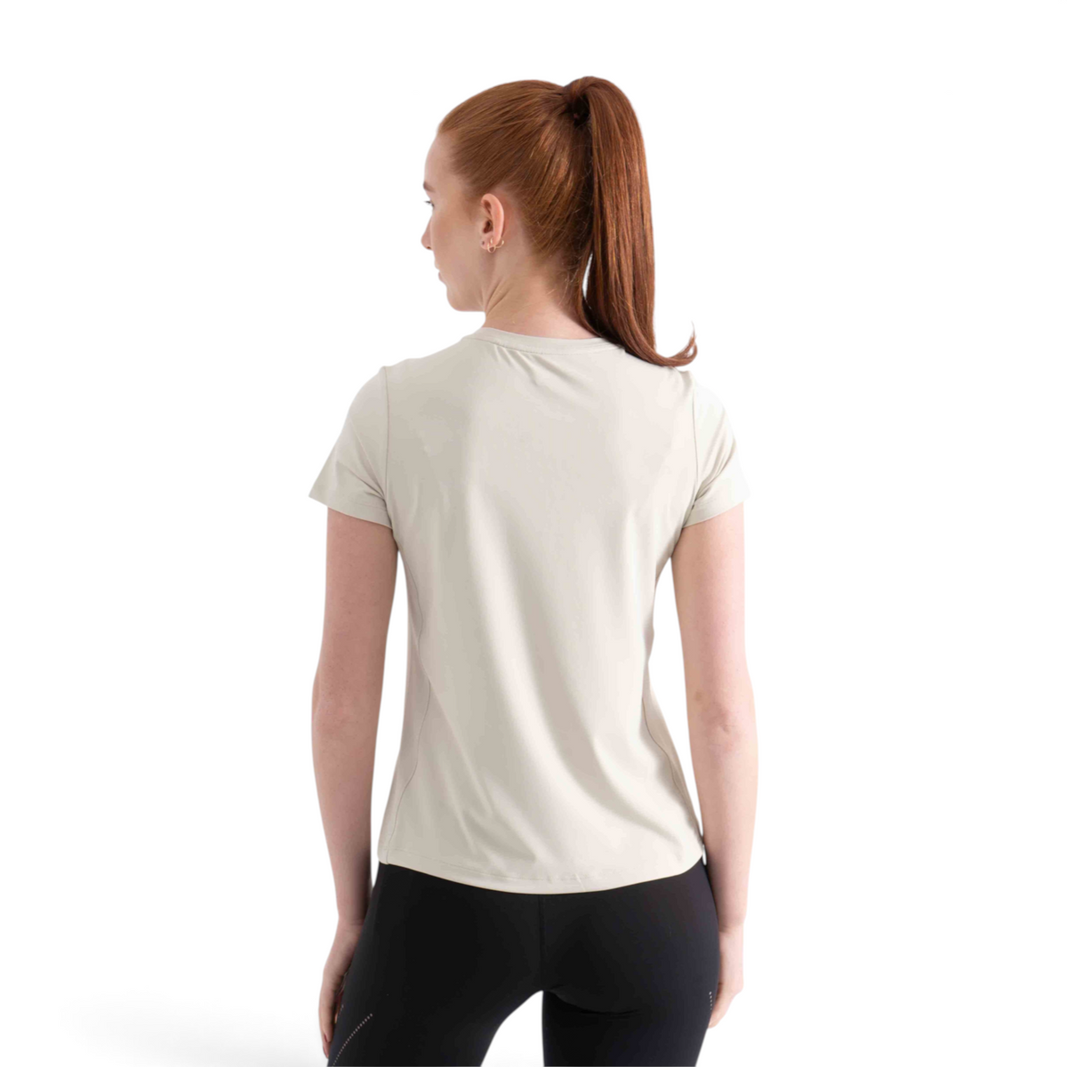 Woman wearing a beige FRG SS TEE short-sleeve athletic shirt, back view, against a white studio background.