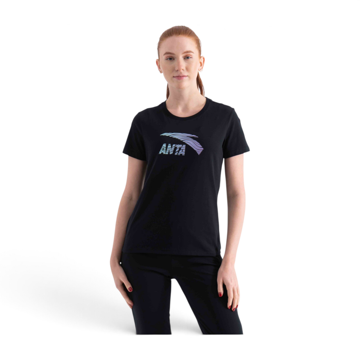 A woman wearing a black FRG short-sleeve t-shirt with a colourful graphic logo on the chest.
