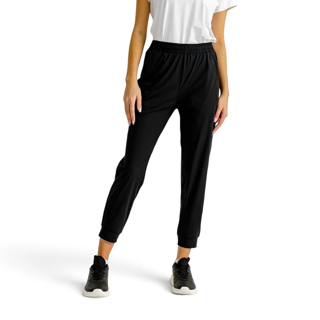 FRG knit ankle pants in black with an elastic waistband and cuffs, worn by a model with a white top and sneakers.