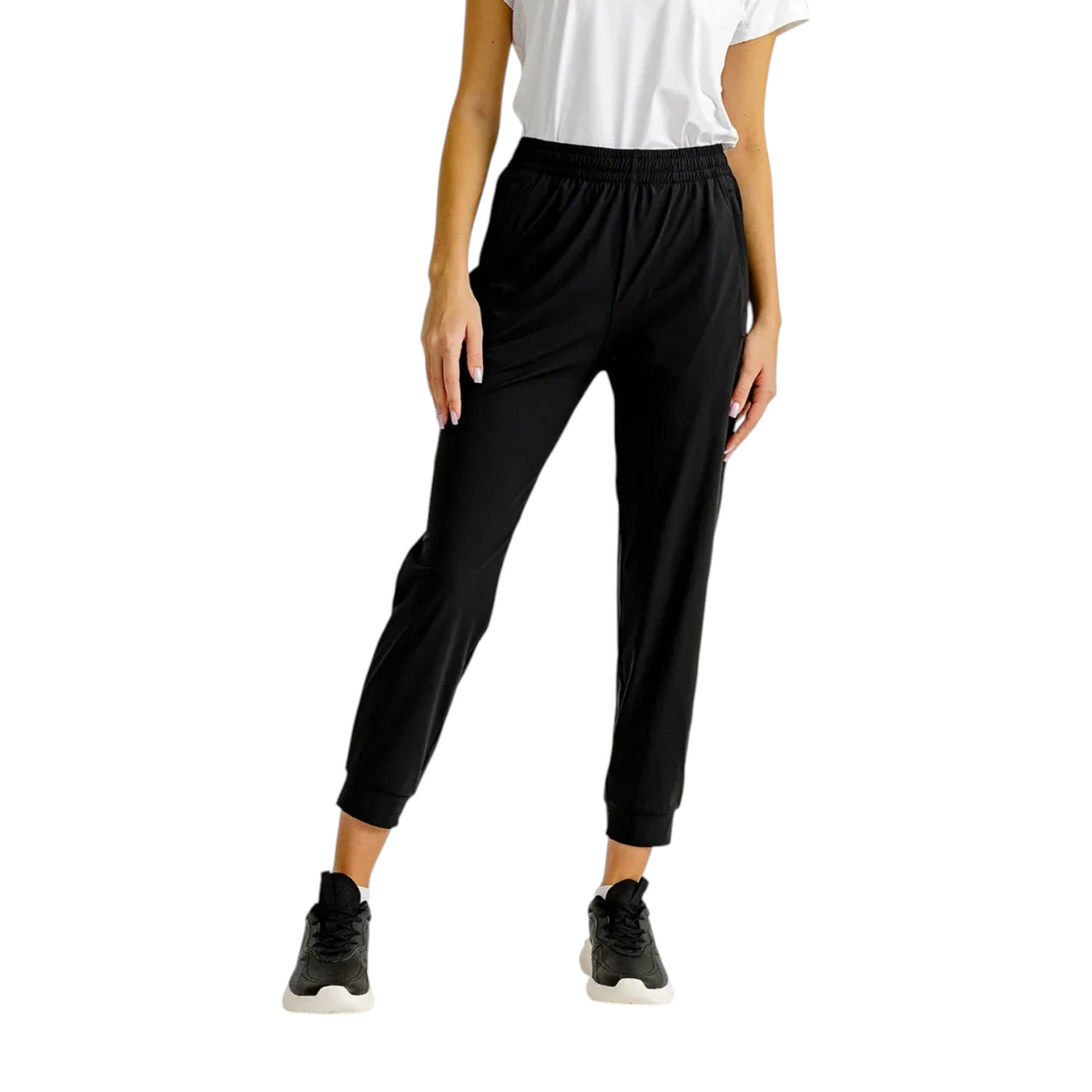 FRG knit ankle pants in black with an elastic waistband and cuffs, worn by a model with a white top and sneakers.