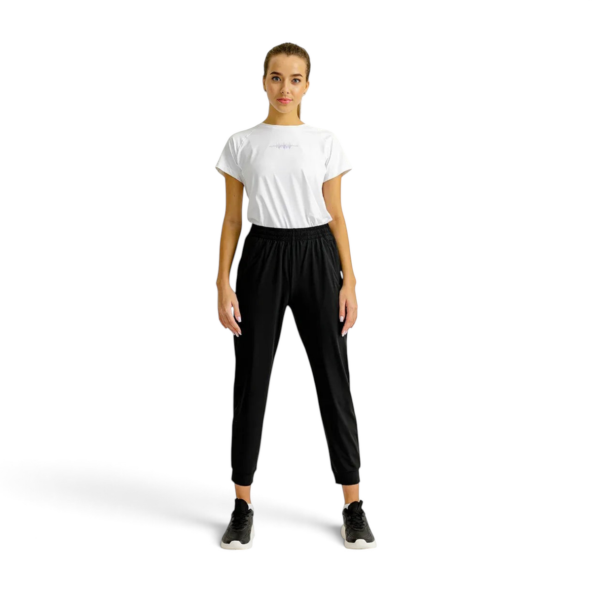 Model wearing FRG black knit ankle pants and a white t-shirt in a studio setting