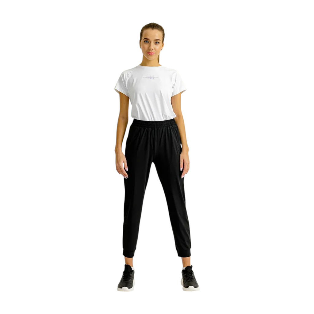 Model wearing FRG black knit ankle pants and a white t-shirt in a studio setting