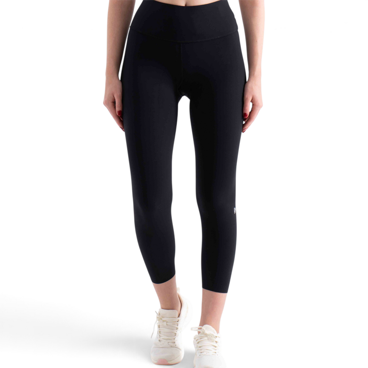 FRG black high-waisted ankle-length leggings worn by a model with white sneakers