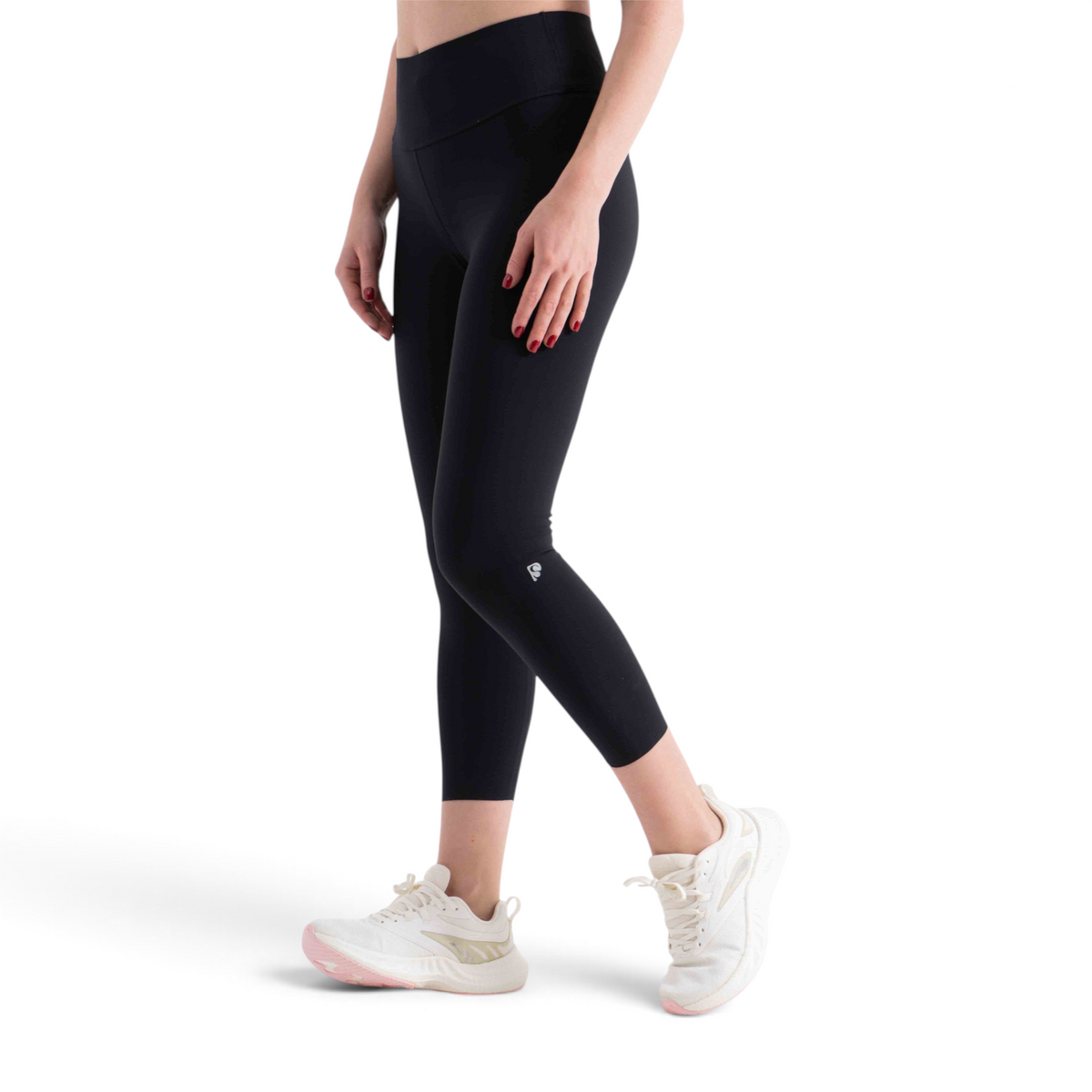FRG tight ankle pants in black, featuring a high-waisted design and cropped length worn with white athletic sneakers.