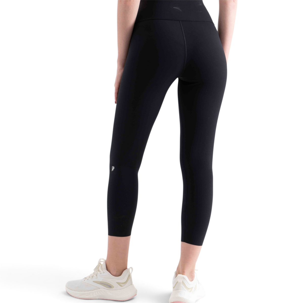 FRG tight ankle pants in black, featuring a high-waisted fit and cropped length, worn with white athletic sneakers.