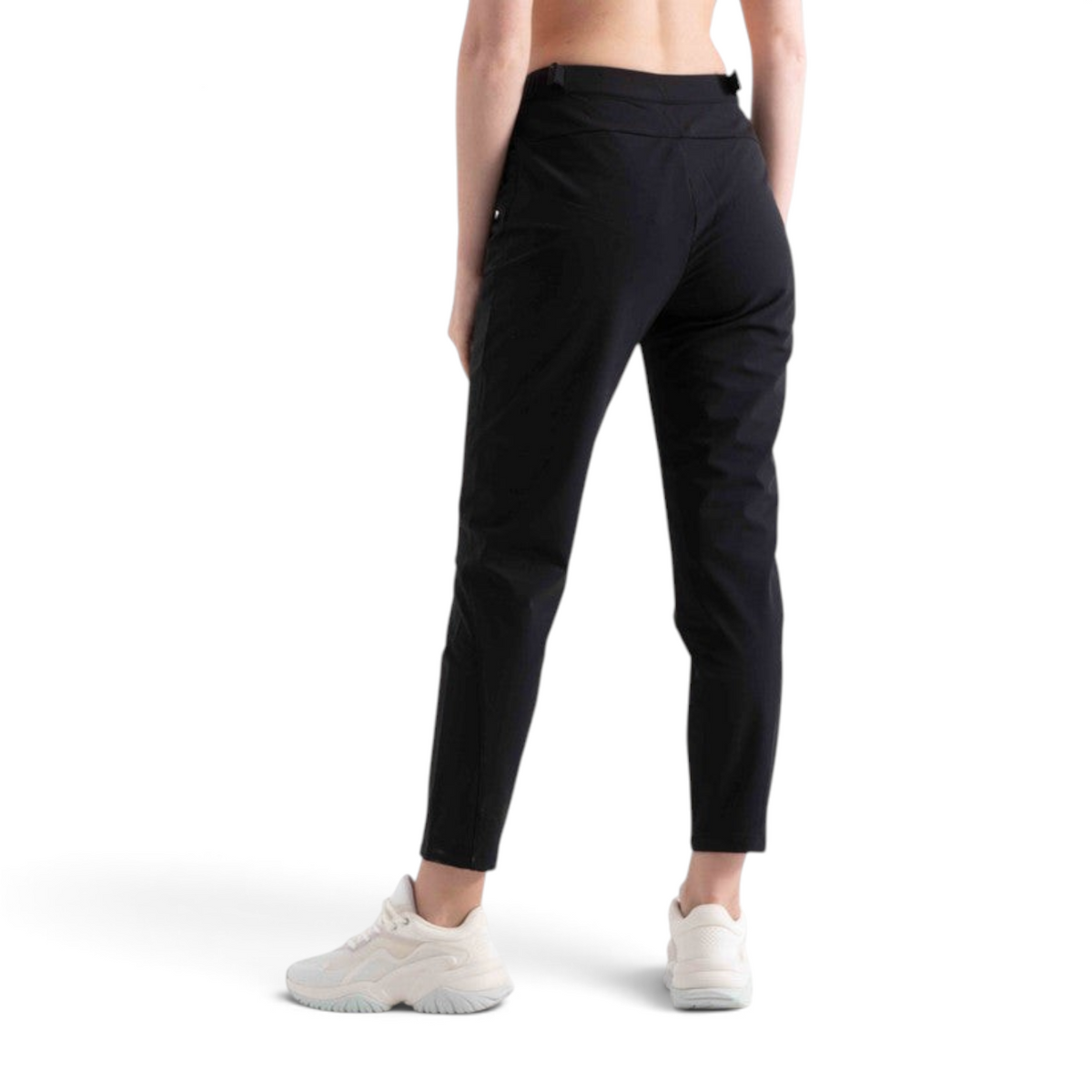 FRG women's black woven track pants for cross training, shown from the back view with white athletic sneakers.