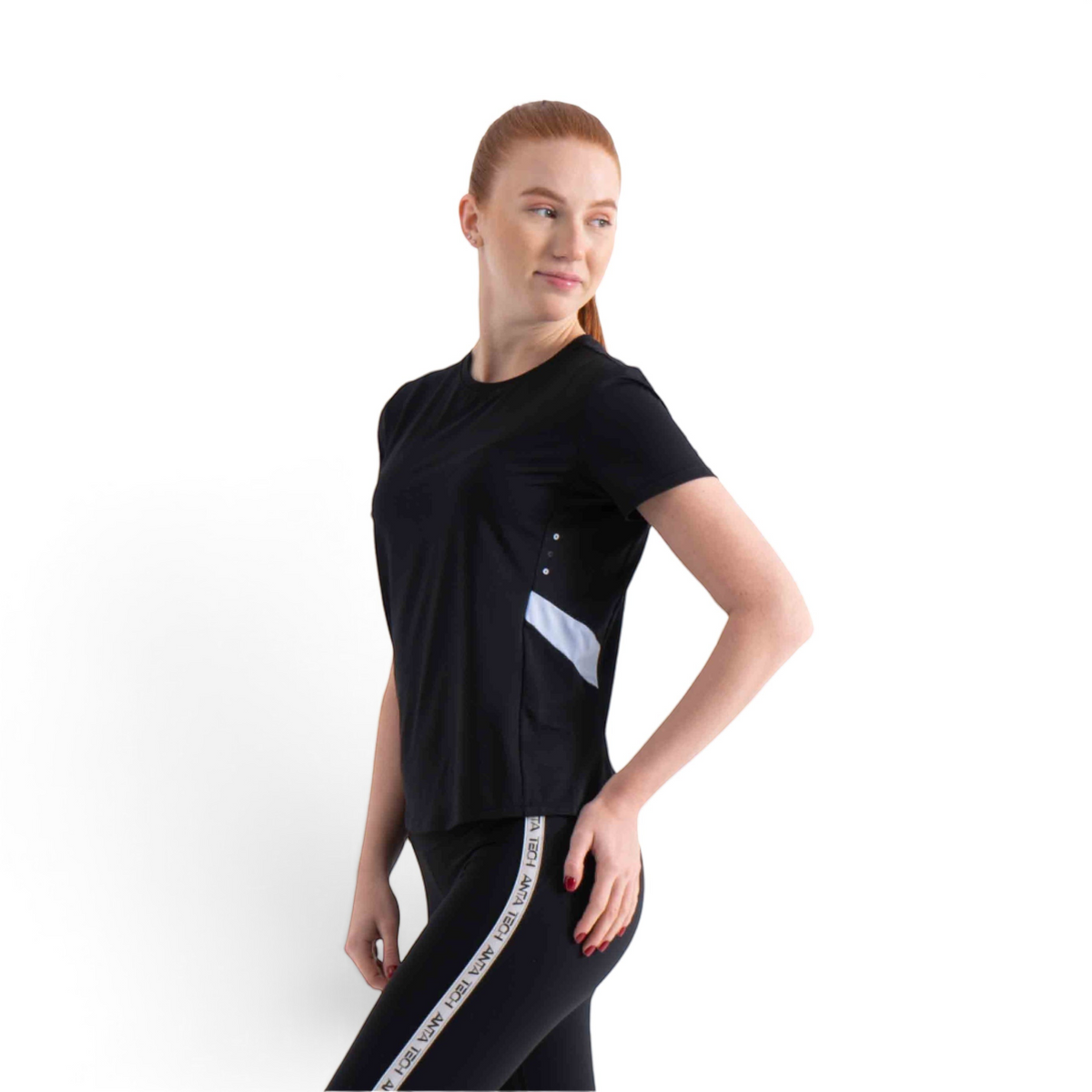 FRG black short sleeve athletic t-shirt with white side panel detail worn by a woman looking over her shoulder