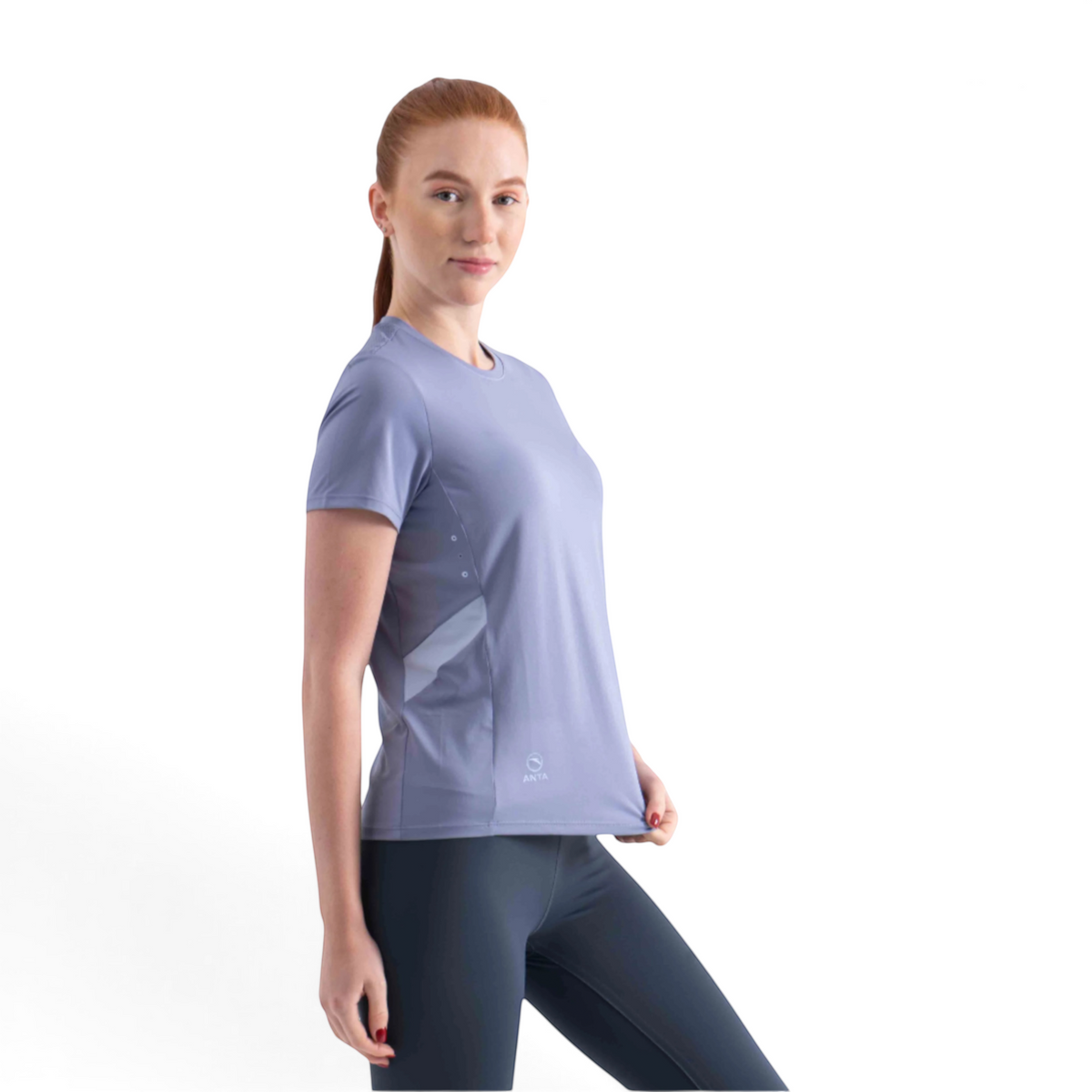 A woman wearing a FRG light purple short-sleeve athletic t-shirt with side panel detailing, isolated on white.
