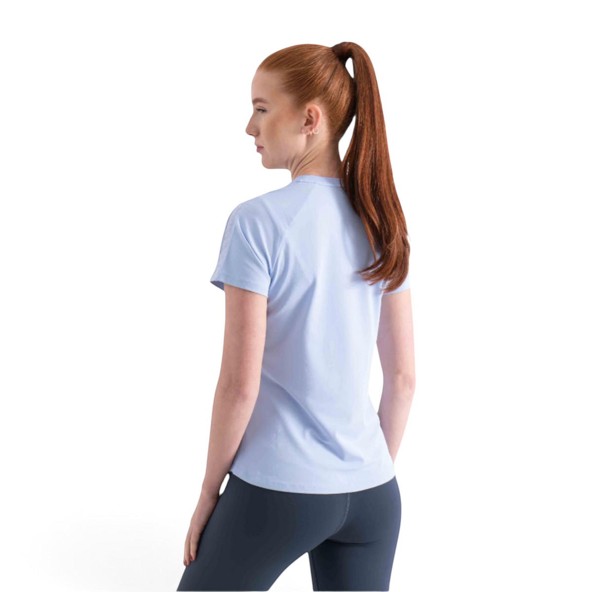 FRG light blue short sleeve athletic tee worn by a woman with a high ponytail, back view