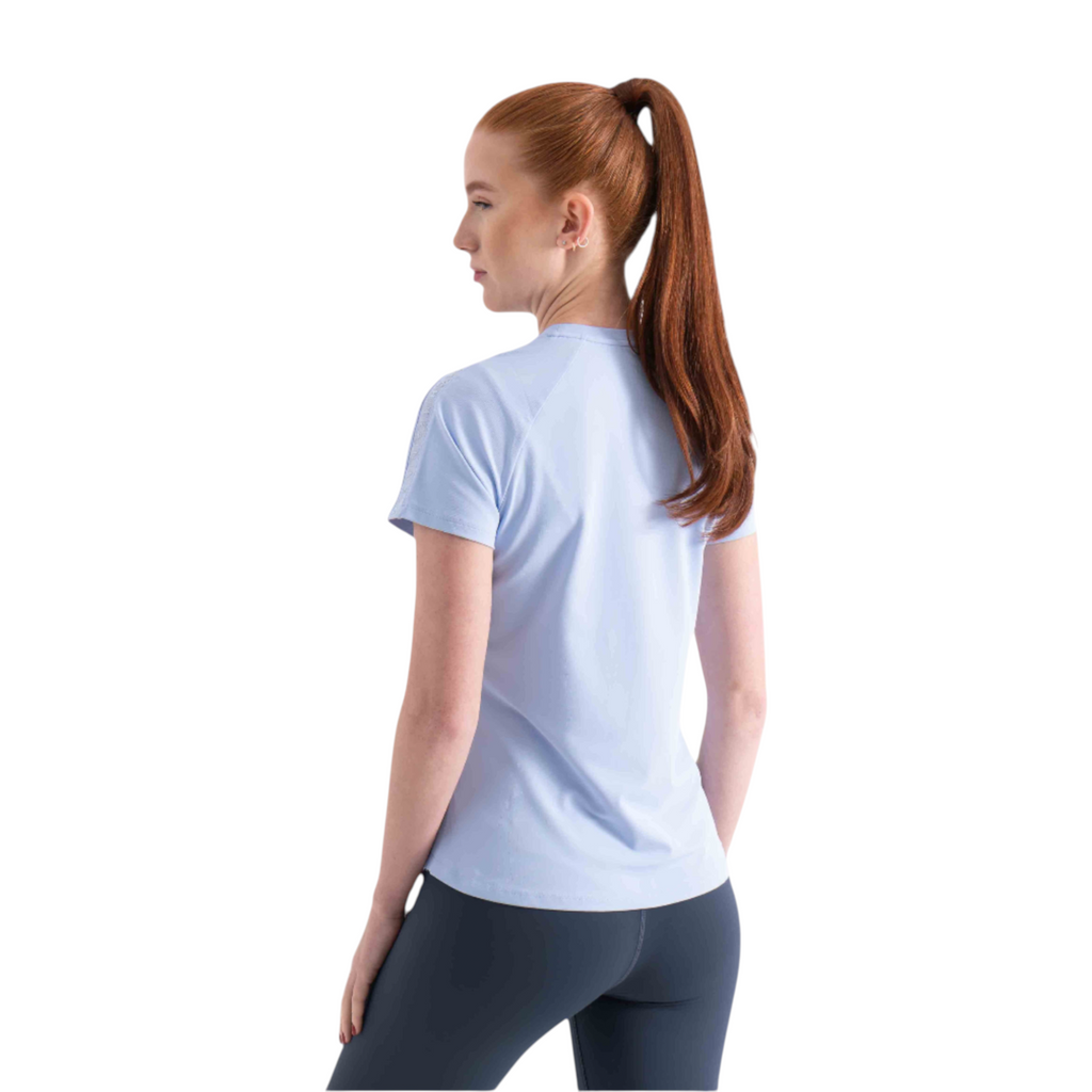 FRG light blue short sleeve athletic tee worn by a woman with a high ponytail, back view