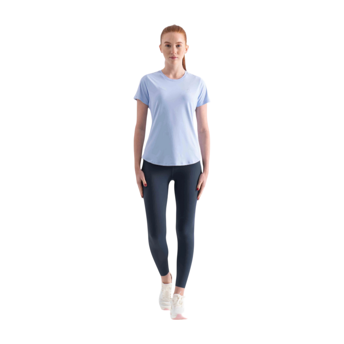 FRG SS TEE in light blue worn by a woman with dark leggings and white sneakers against a white background