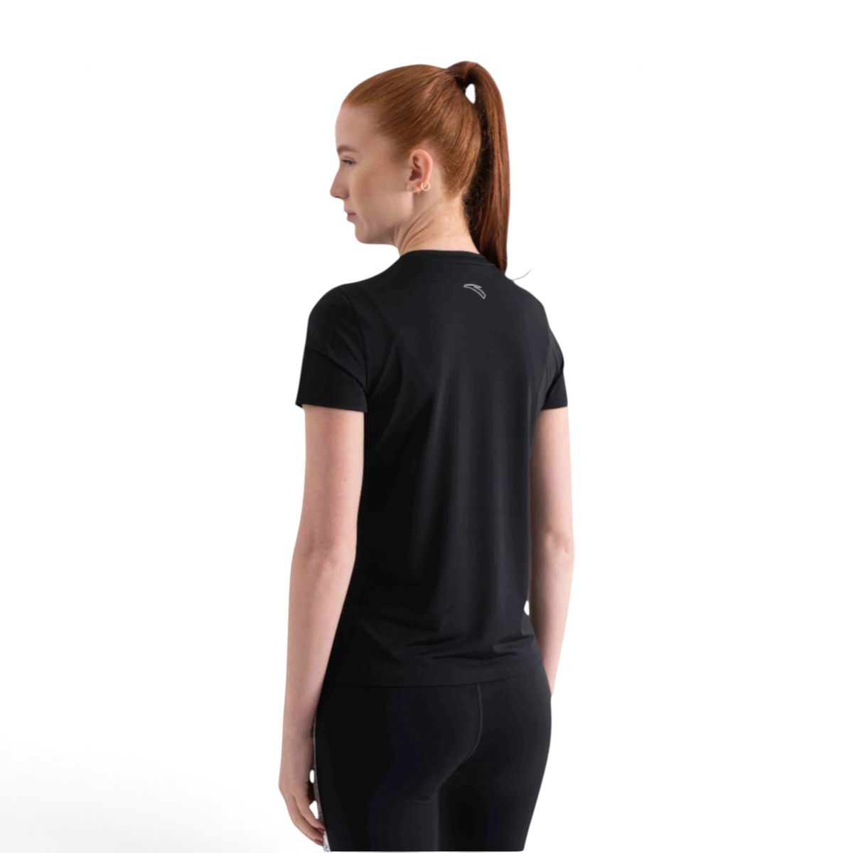 A woman wearing a black FRG short sleeve athletic t-shirt with a small logo on the back, viewed from behind.